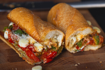 Sandwich with baked tomatoes, bell peppers and cheese