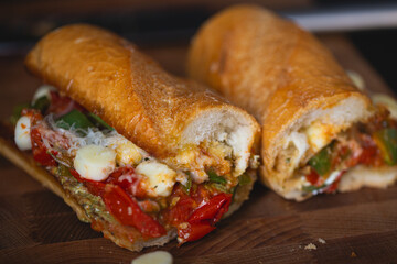 Sandwich with baked tomatoes, bell peppers and cheese