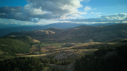 Fototapeta premium Drone aerial view of Castel del Monte, Abruzzo, a medieval hilltop village with ancient stone architecture and panoramic landscapes