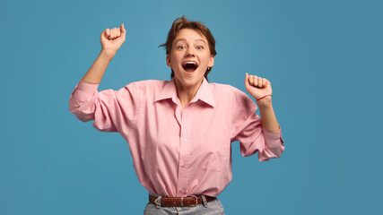 Happy woman with surprised joyful expression raising hands in excitement. Concept of achievement,...
