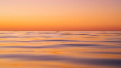 Vibrant sunset over calm ocean water with soft waves and colorful sky