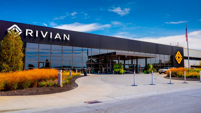 Covered entryway to front of factory in Normal Illinois displaying Rivian name and brand logo with summer on September 9, 2025.