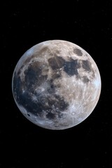 Obraz premium vertical photo bright full moon illuminates dark night sky, revealing its surface details and craters. Spectacular and captivating, scene highlights beauty of lunar features