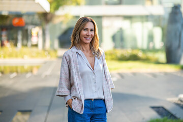 Businesswoman smiling standing outdoors in casual wear
