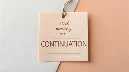 Square paper tag with continuation text showing still moving on