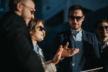 A group of professionals interacting and collaborating in an urban outdoor business environment.