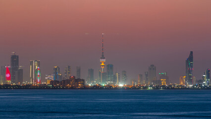 Skyline with Skyscrapers day to night timelapse in Kuwait City downtown illuminated at dusk. Kuwait City, Middle East