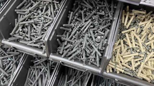 Grey containers with various types of fasteners. Dowels-nails