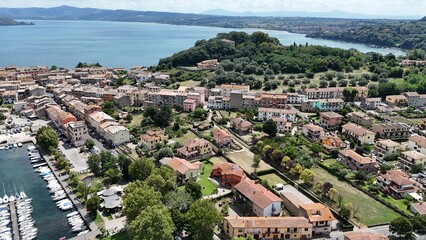 Drone aerial view of Capodimonte, Lazio, overlooking Lake Bolsena with charming streets, medieval architecture, and lakeside scenery