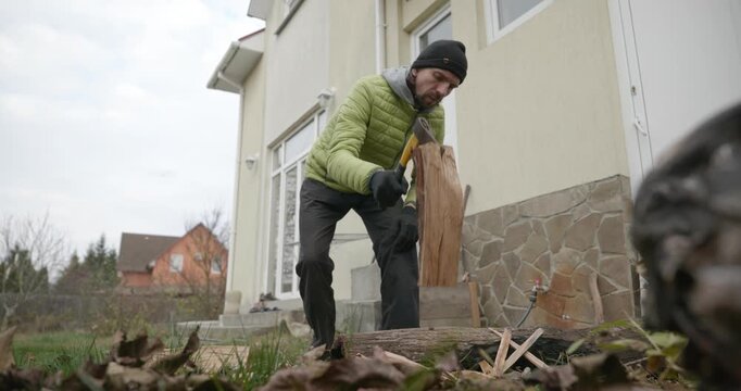 Man Chops Firewood with Axe in the Backyard 4K Slow motion 60 fps 10-bit