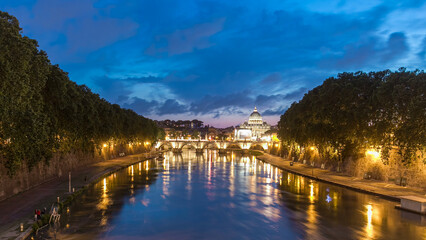 Fototapeta premium St. Peter's Basilica, Saint Angelo Bridge and Tiber River after the sunset day to night timelapse hyperlapse