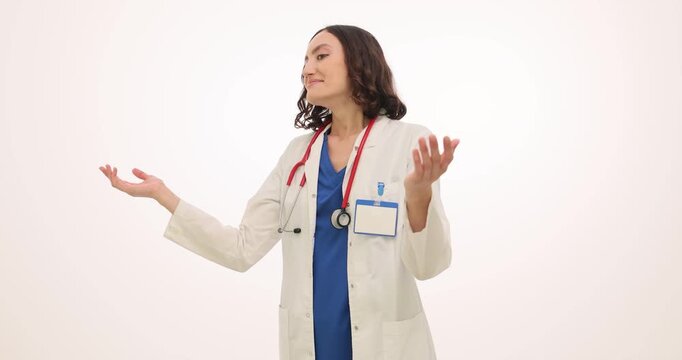 Woman doctor smiles warmly clapping hands together on white background. Female shows encouragement and congratulation by clapping hands. Slow motion