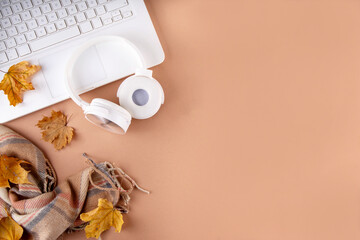 Cozy autumn background with laptop, fall leaves, pumpkins and plaid. Autumn office work, education...