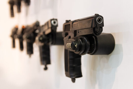 Traumatic pistols on a window of armament store