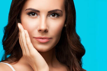 Wow! closeup face portrait - surprised, astonished shocked brunette cute woman touching hand her cheek, isolated against green color background. Toothache.