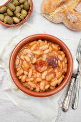 Asturian fabada soup with white beans and blood sausage served in bowl