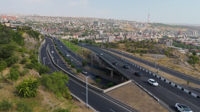 31.08.2025  Aerial shot traffik road with diving cars in Yerevan, Armenia. Vehicles, cars, traffic during day time. Traffic road with cars. City in background.