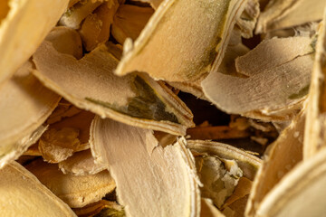 Extreme close-up of light brown pumpkin seed husks, abstract food texture