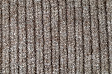Detailed close-up of brown knit wool fabric with a vertical ribbed pattern