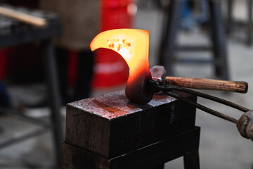 Blacksmith working iron axe