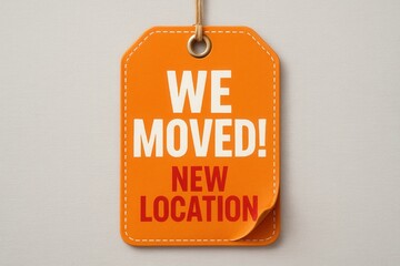WE MOVED! NEW LOCATION announcement tag in bold lettering, vibrant retail promo with an eye-catching design on transparent background.
