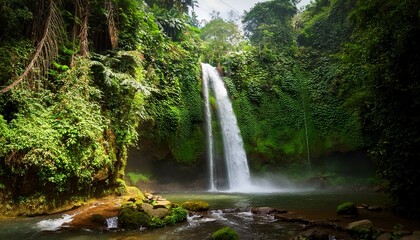 Obraz premium curtain waterfall in lush jungle at benang kelambu lombok