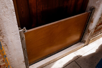 Flood protection barrier installed at the bottom of a residential door in Venice, Italy, used to...