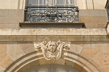 Architecture detail with sculpted face and balcony of the Opera of Rennes, France 