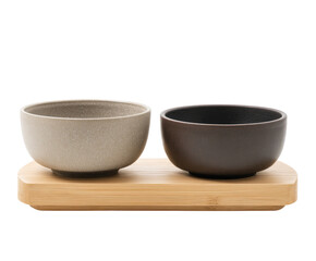 Two matching ceramic bowls on a light brown bamboo tray