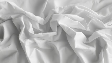 Disheveled crumpled sheets lie in a chaotic state with no clear pattern of folds or arrangement,