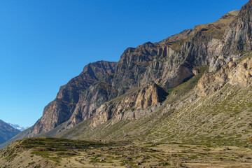 Dramatic mountain peak with rugged cliffs and rocky terrain, showcasing the raw beauty of barren landscape under clear blue sky. Kabardino-Balkaria, Chegemsky district