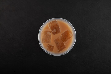 Khopi coffee or Kopi Sanger in disposable plastic cup, top view. Popular refreshing drink. Iced coffee. Take away food