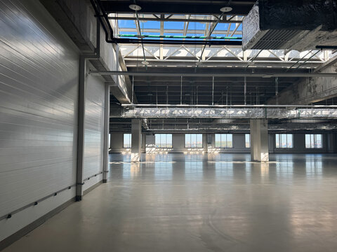 Industrial space or empty manufacturing bay. Vacant production facility. Spacious, modern industrial unit. Big empty box.