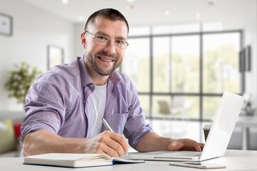 Fototapeta premium Confident man working on laptop in modern in office