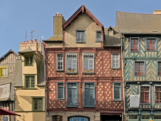 Colourful timber framing houses with beautiful abstract patterns in the city of Rennes, France. Low angle view 