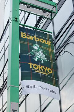 TOKYO, JAPAN - October 5, 2025: A banner on a lamppost in Shibuya advertising a Barbour store.
