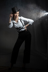 Confident pose in classic pants and harness. Retro noir atmosphere