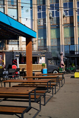 Outdoor urban food truck seating area with wooden benches