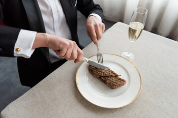 Elegant man in suit enjoying a festive Christmas dinner celebration at a fine restaurant
