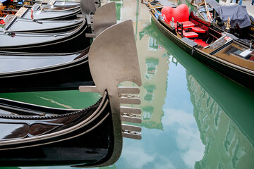 Close-up of the Ferro di Prua on Traditional Black Venetian Gondolas Floating on Emerald Water,...