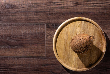 Coconut on Wooden Plate, Top View