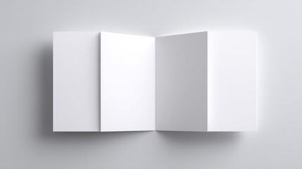 Fototapeta premium Blank white brochure mockup spread open on a plain gray surface