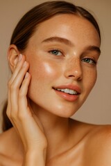 Woman with natural freckles smiling and touching her glowing, hydrated skin, showcasing health and beauty