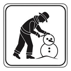 Person wearing a hat and warm clothing building a snowman in the snow during winter season
