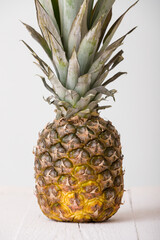 Closeup fresh juicy pineapple on a white background. Pineapple on a wooden table