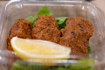 Making raw meatballs ( Turkish: Cig Kofte ) on wooden background	