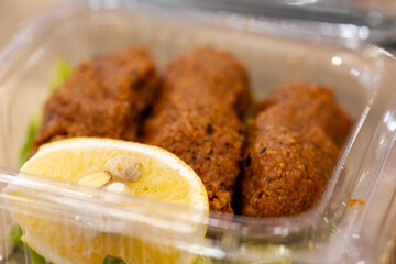 Making raw meatballs ( Turkish: Cig Kofte ) on wooden background	