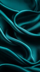 Obraz premium Luxurious teal satin fabric elegantly drapes, showcasing flowing curves and deep hues that symbolize richness and sophistication, perfect for fashion or interior design projects.