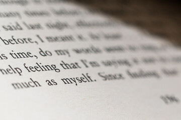 Close-up of a printed page with a quote about self-reflection and personal feelings in soft focus