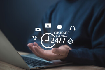 Businessman holding 24-hour customer service icon with communication symbols, representing online support, help desk, client care, and business assistance through technology. Contact us concept